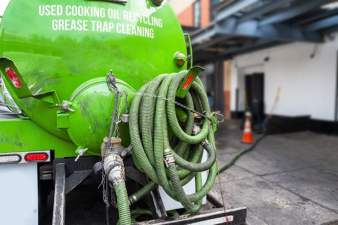 grease trap pumping truck in action in Bellwood